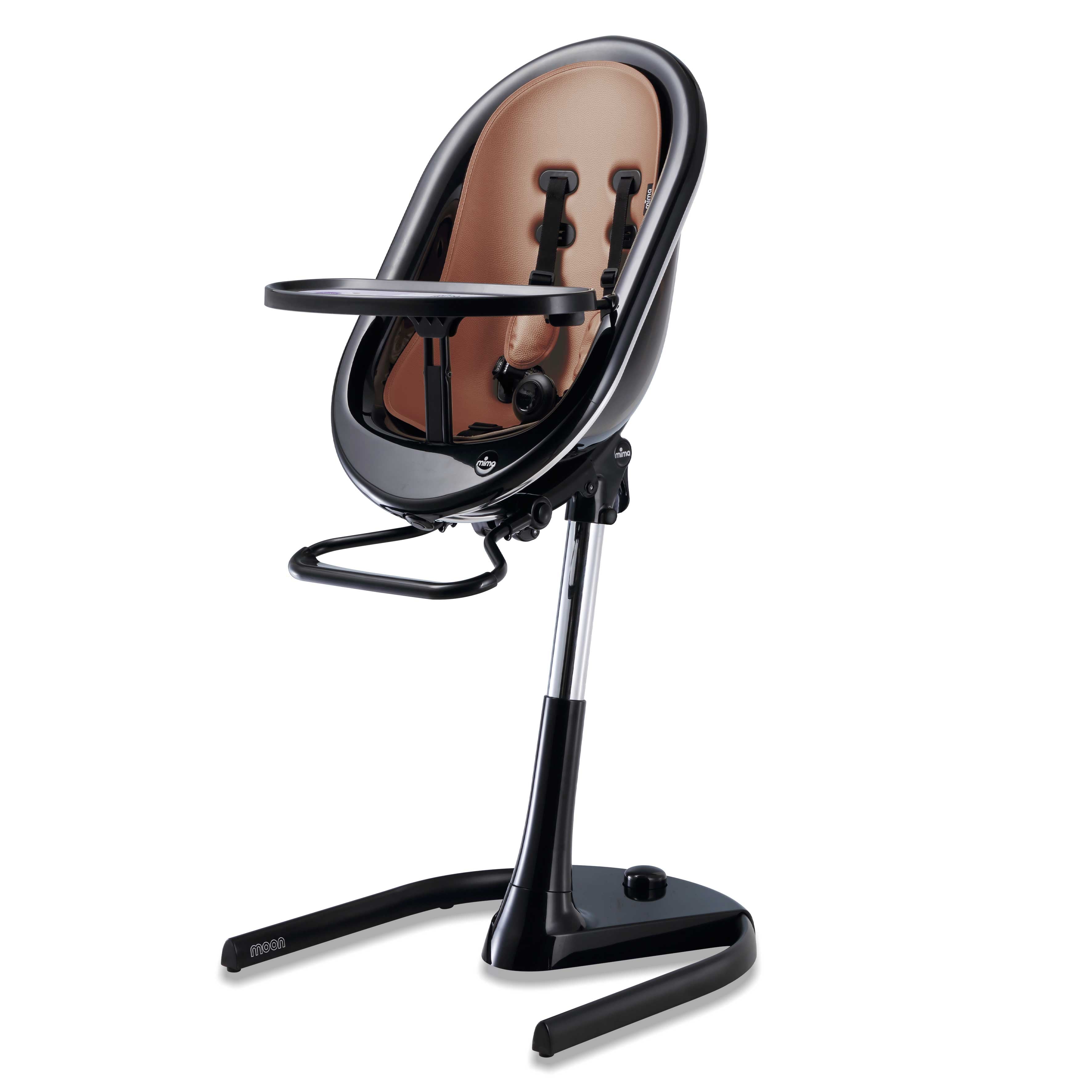 Black Mima Moon 2G high chair at max height, with camel seat pad, tray, harness and adjustable footrest, right-front view