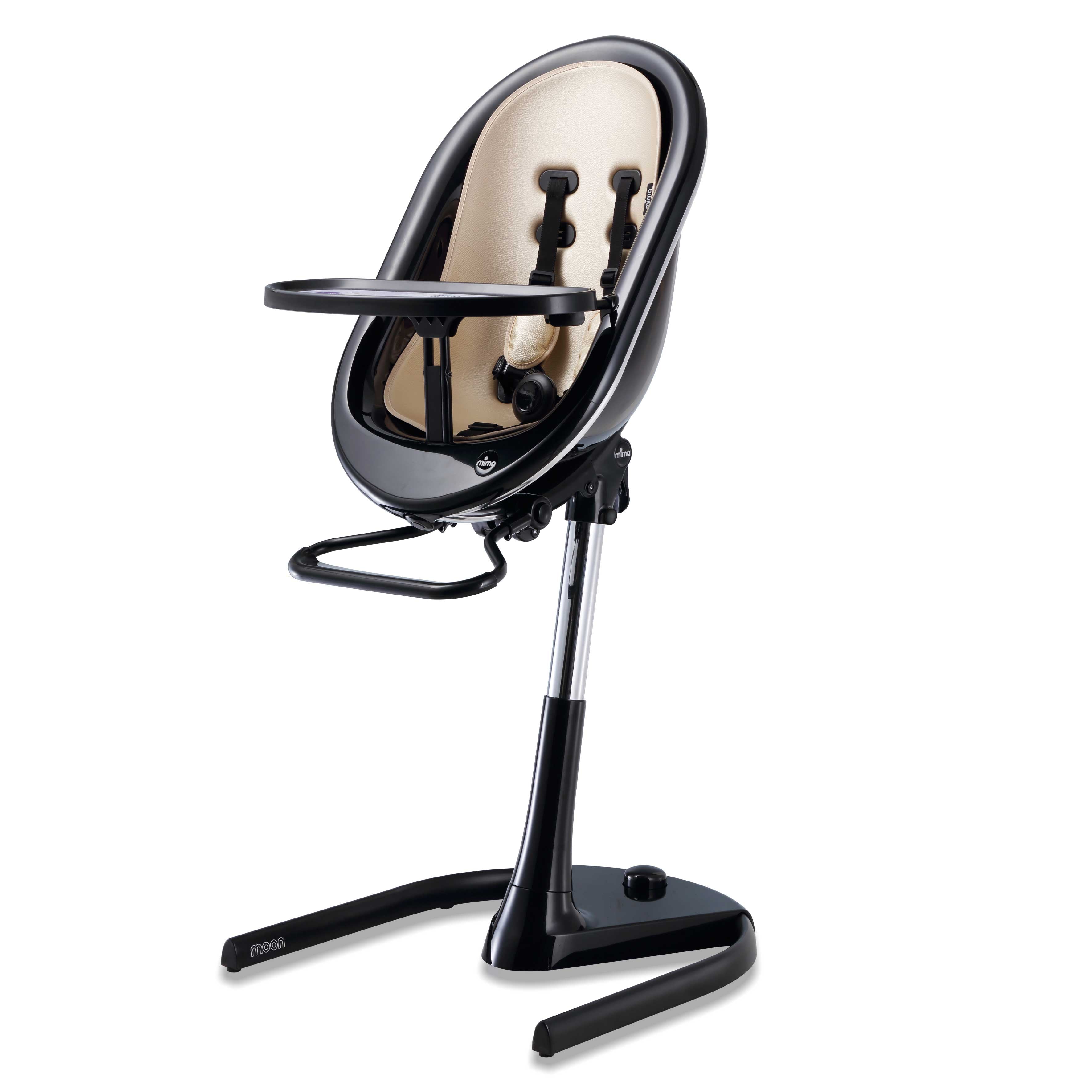 Black Mima Moon 2G high chair at max height, with champagne seat pad, tray, harness and adjustable footrest, right-front view