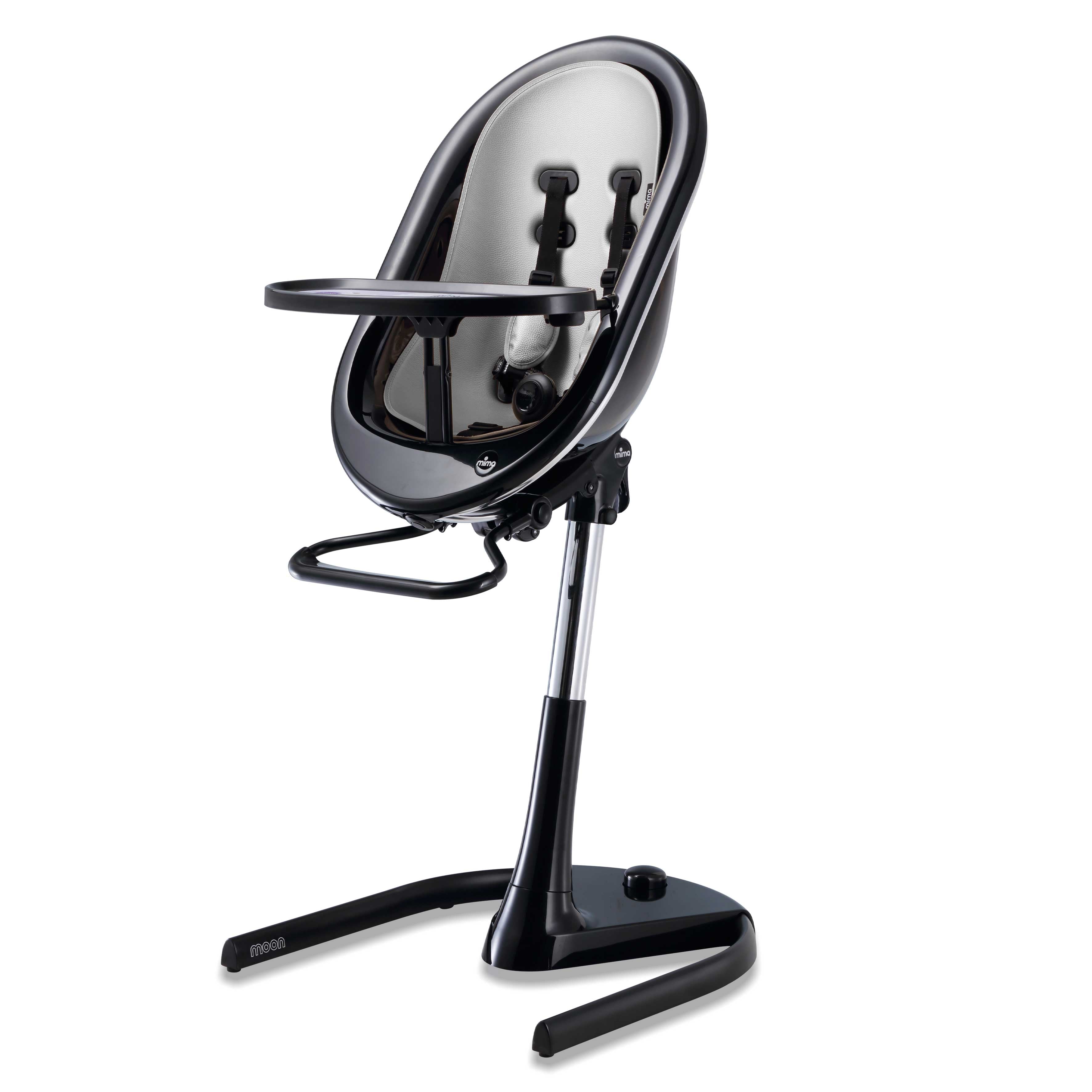 Black Mima Moon 2G high chair at max height, with silver seat pad, tray, harness and adjustable footrest, right-front view