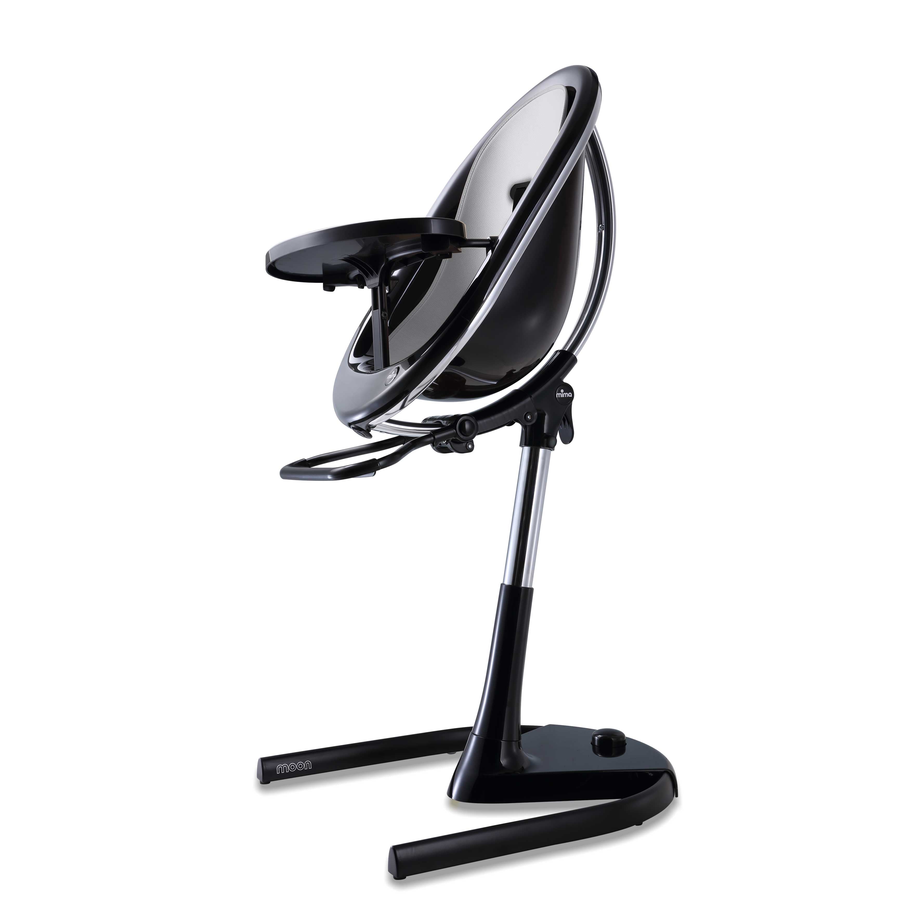 Black Mima Moon 2G high chair with silver seat pad, side view, modern with transparent back