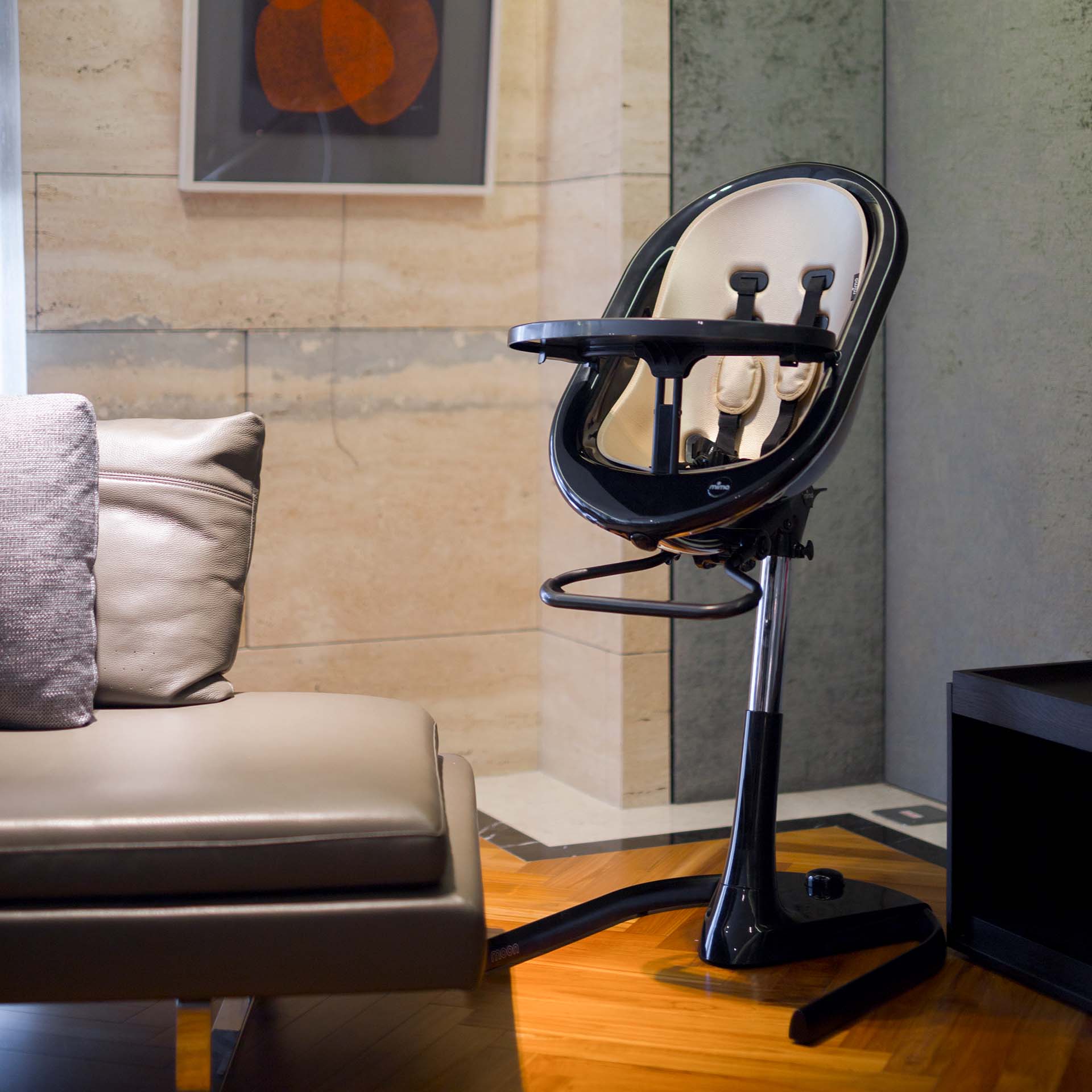 black Mima Moon 2G high chair in high chair mode, indoor living room