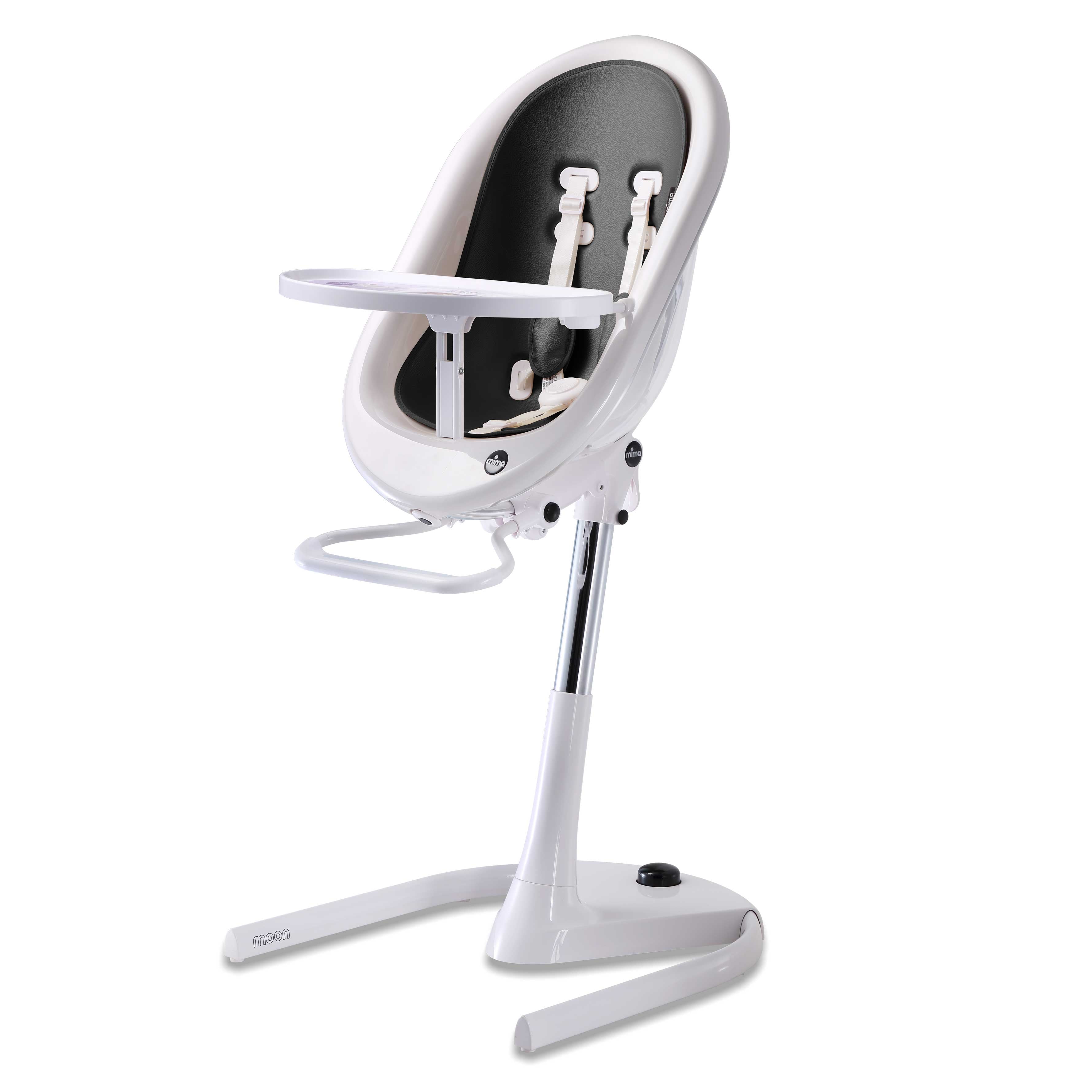 White Mima Moon 2G high chair at max height, with black seat pad, tray, harness and adjustable footrest, right-front view
