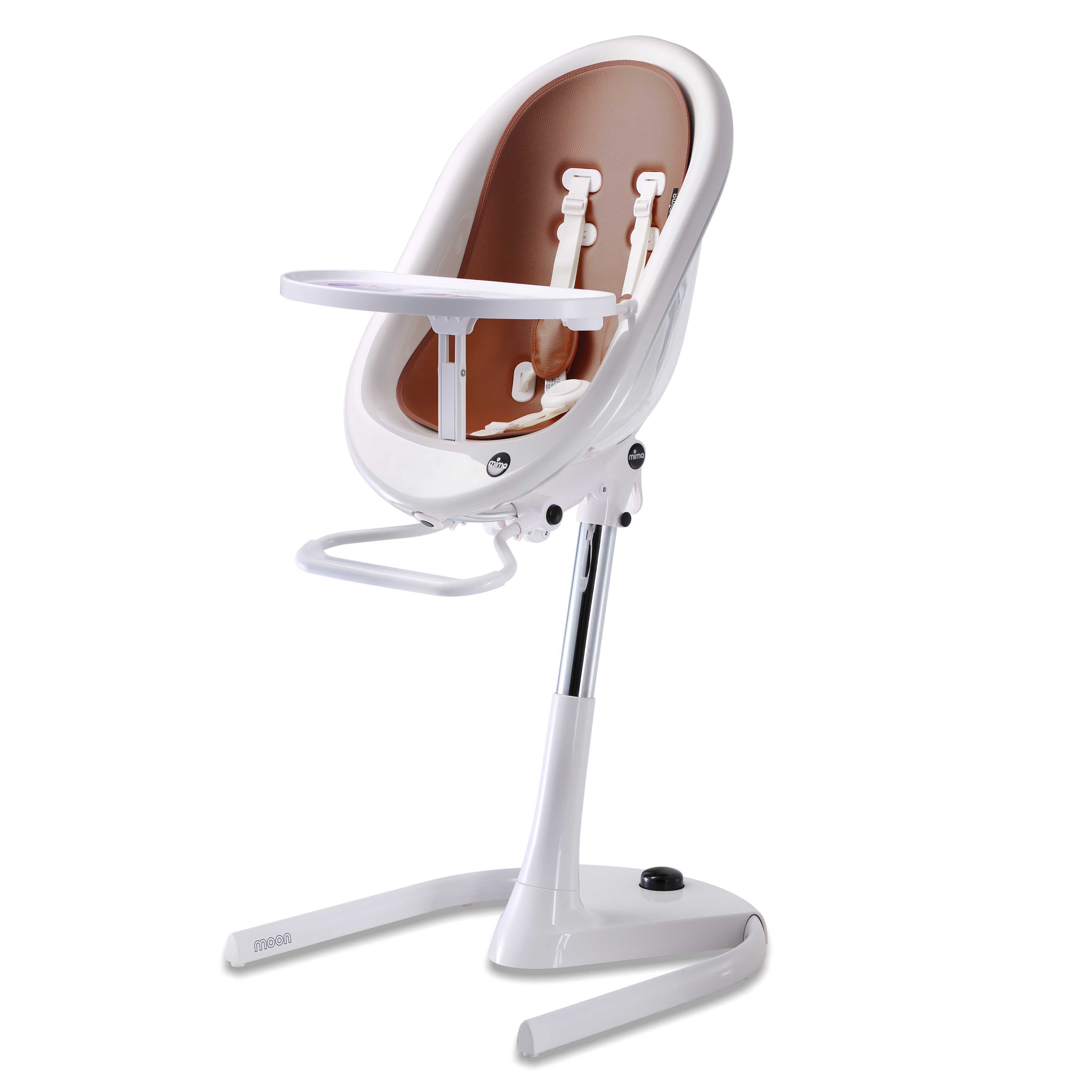 White Mima Moon 2G high chair at max height, with camel seat pad, tray, harness and adjustable footrest, right-front view