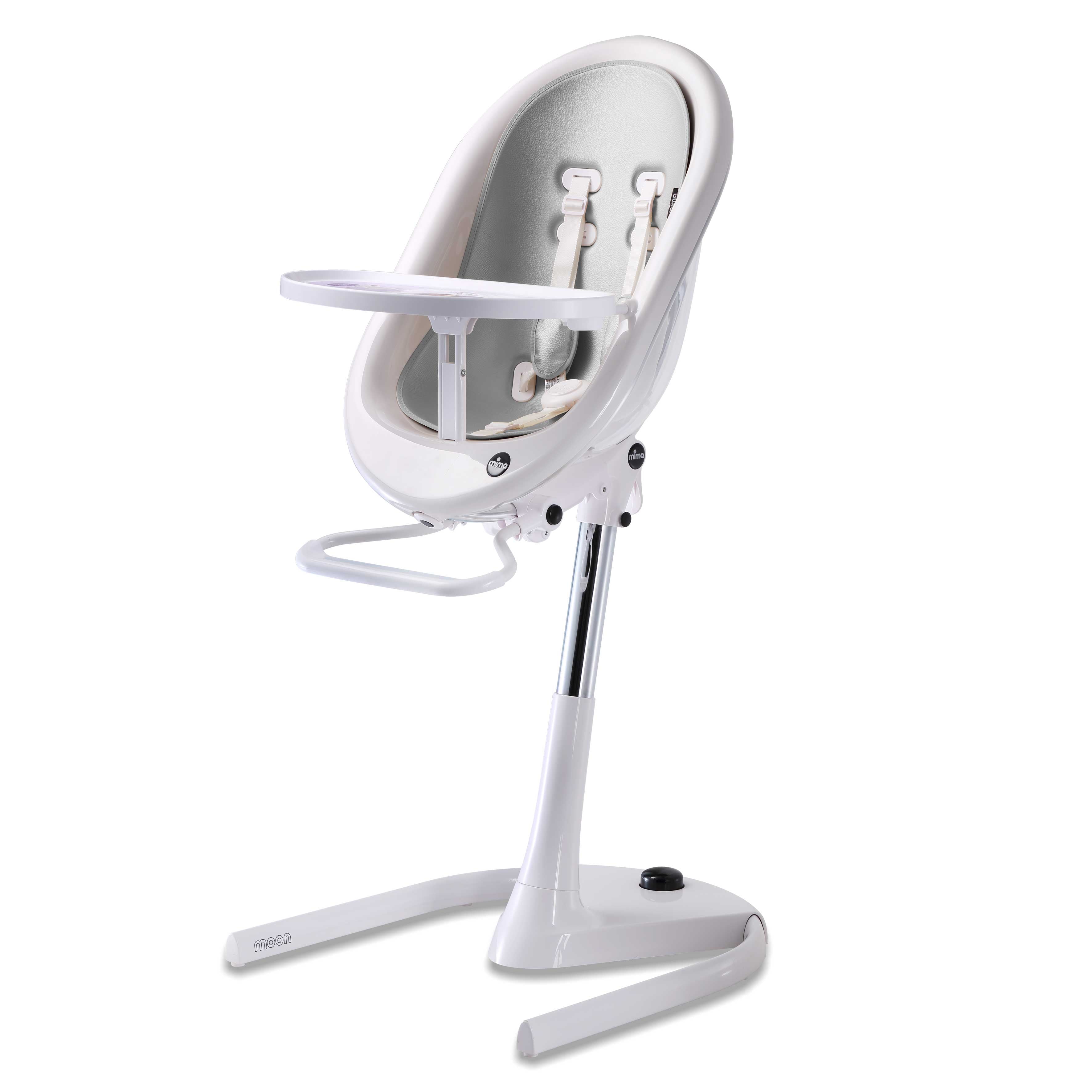 White Mima Moon 2G high chair at max height, with silver seat pad, tray, harness and adjustable footrest, right-front view