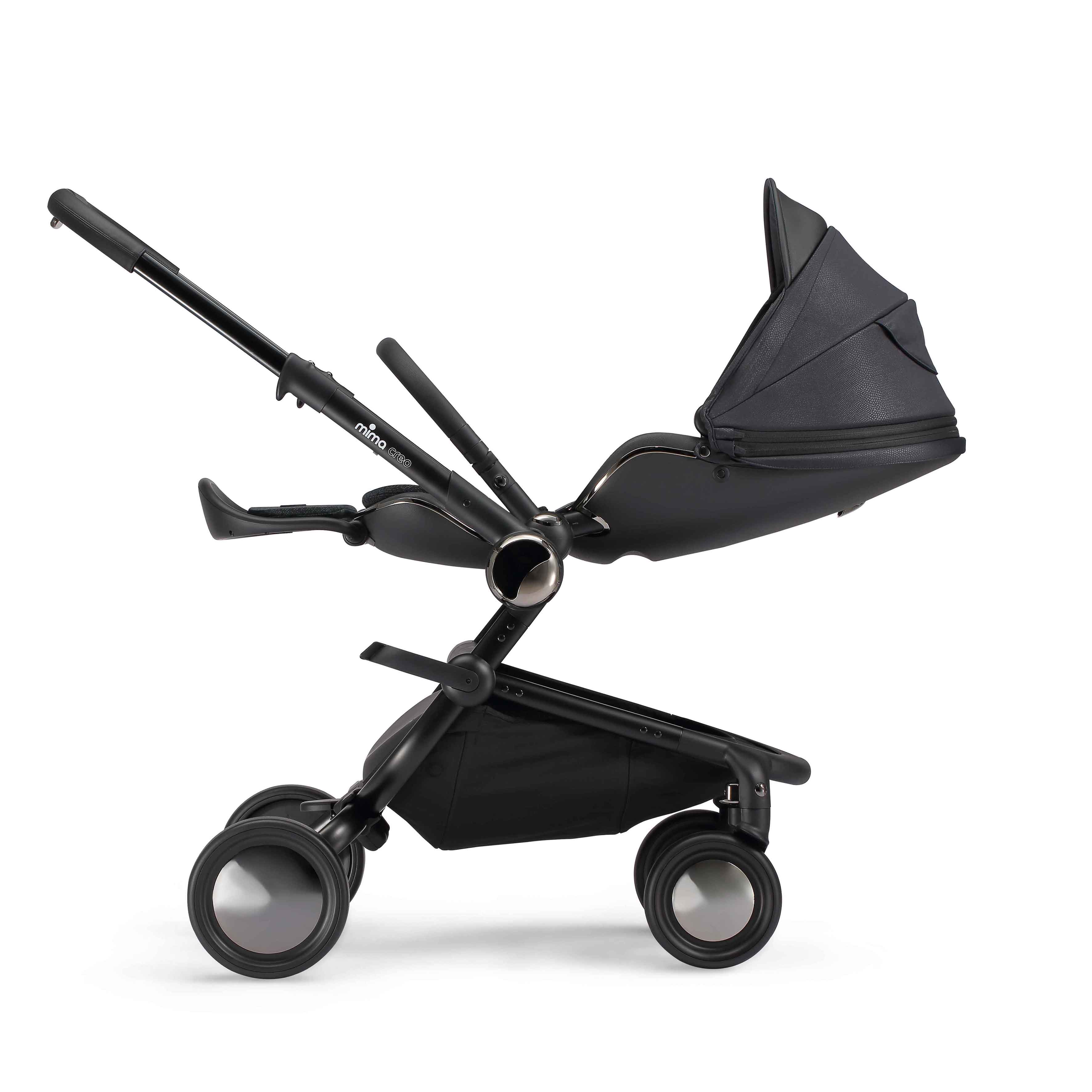 mima creo stroller in black with seat fully reclined into a flat position, side view, facing parents