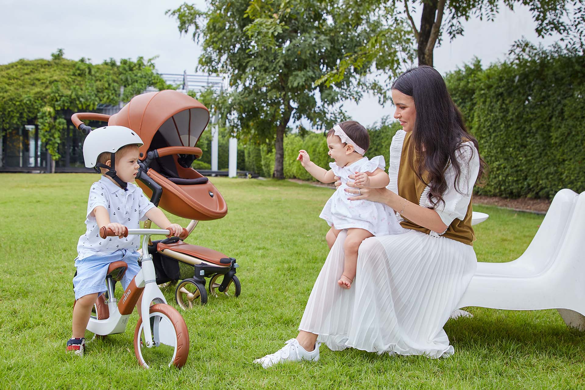 mima xari camel stroller and zoom white balance bike with child and mother in park