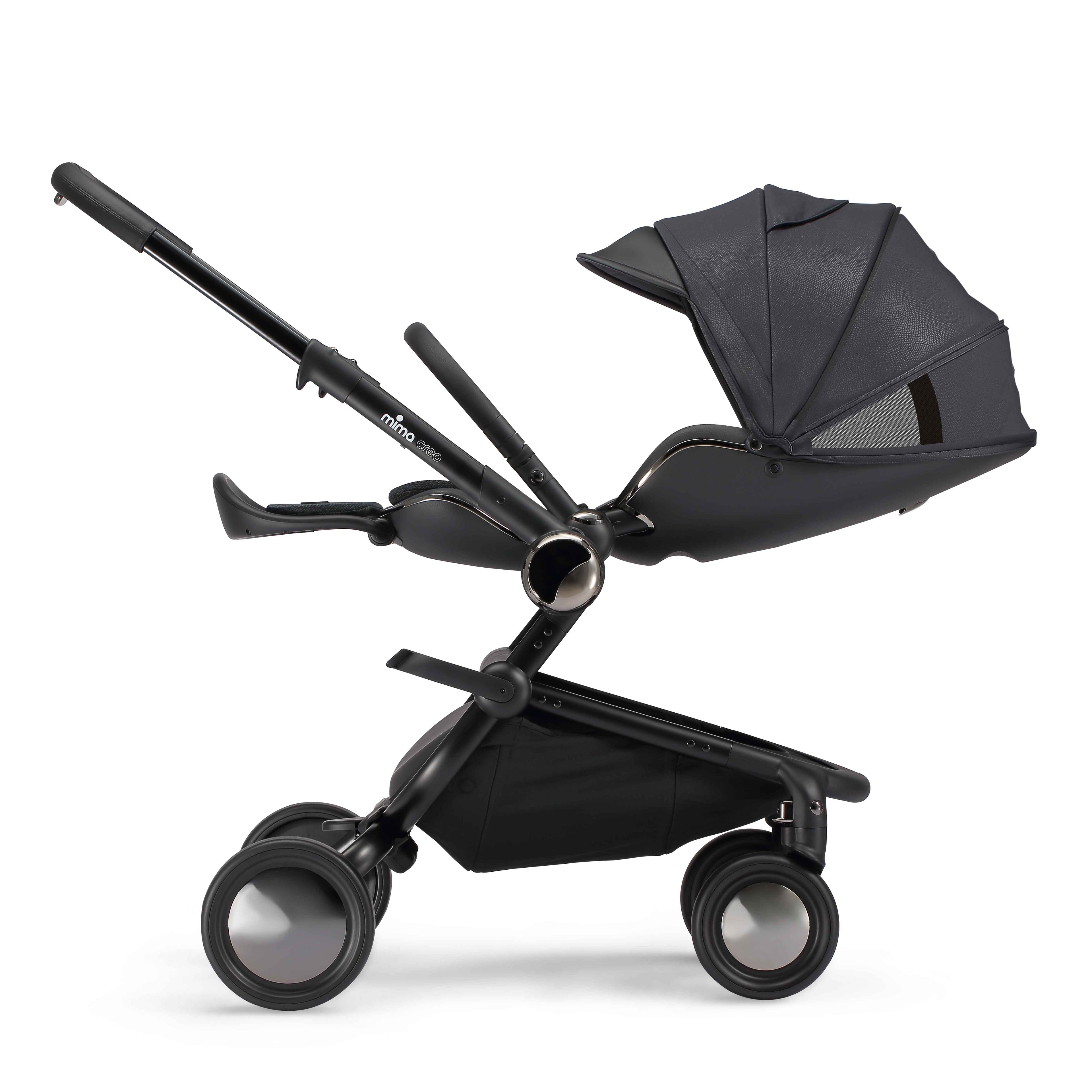 side view of parent facing fully reclined mima creo compact stroller in black