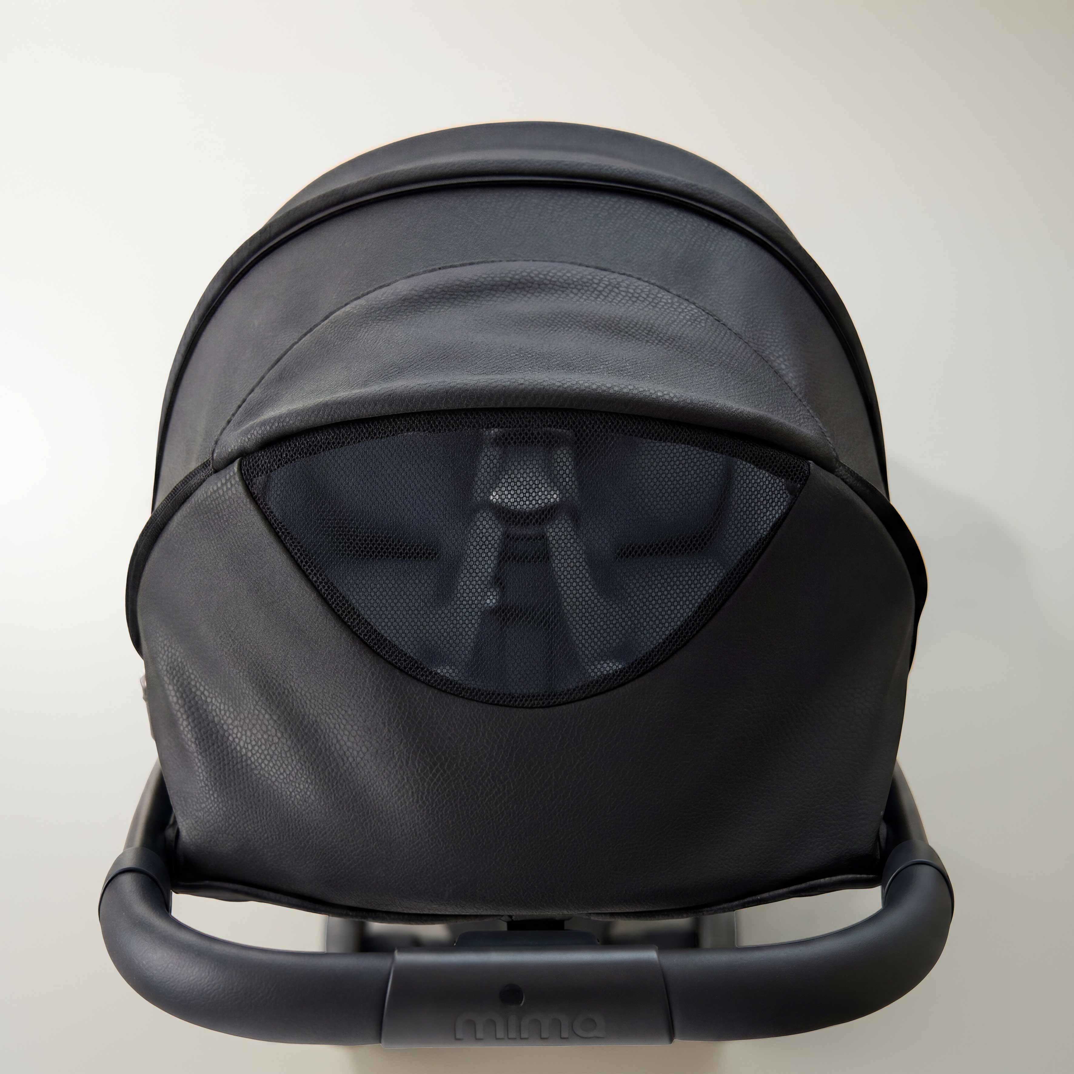 top view of open canopy ventilation window on mima miro stroller in black