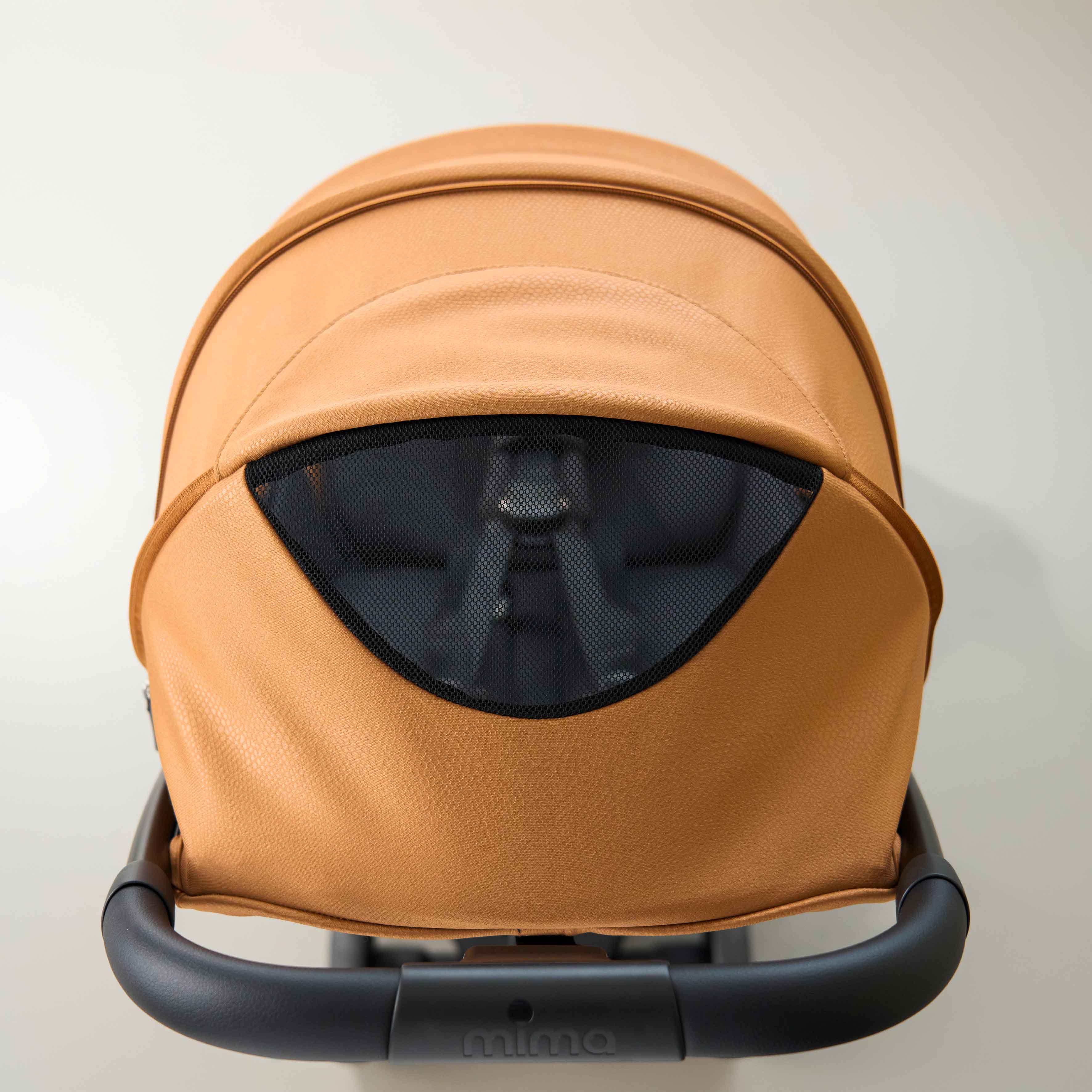 top view of open canopy ventilation window on mima miro stroller in mocha cream