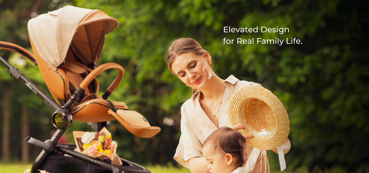 Elevated design for real family life. A parent beside the mima creo stroller in mocha cream.