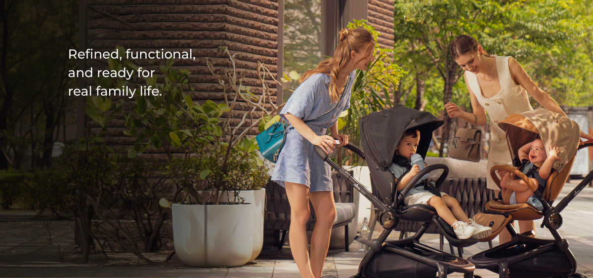 Refined, functional and ready for real family life. Two parents with mima creo strollers in a city courtyard.