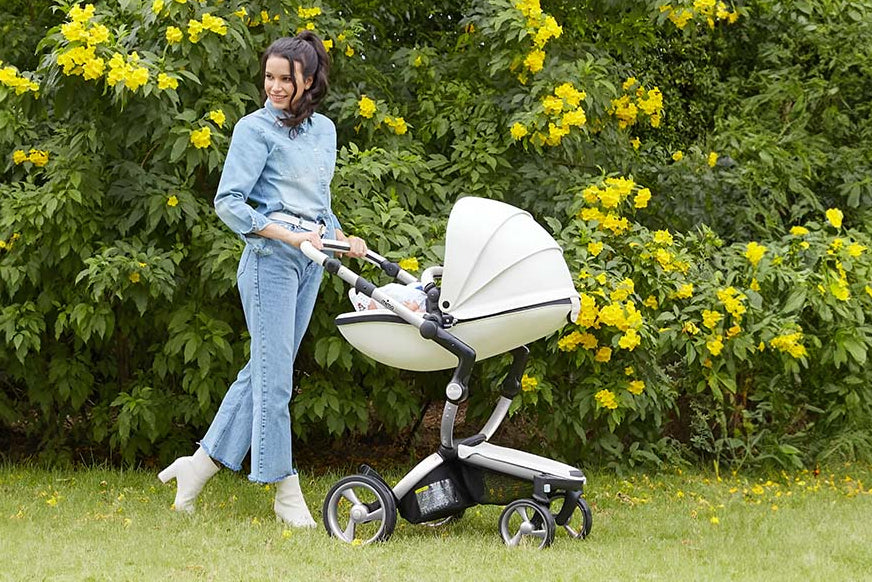 Snow white Mima Xari stroller, mother pushing, outdoor with yellow flowers