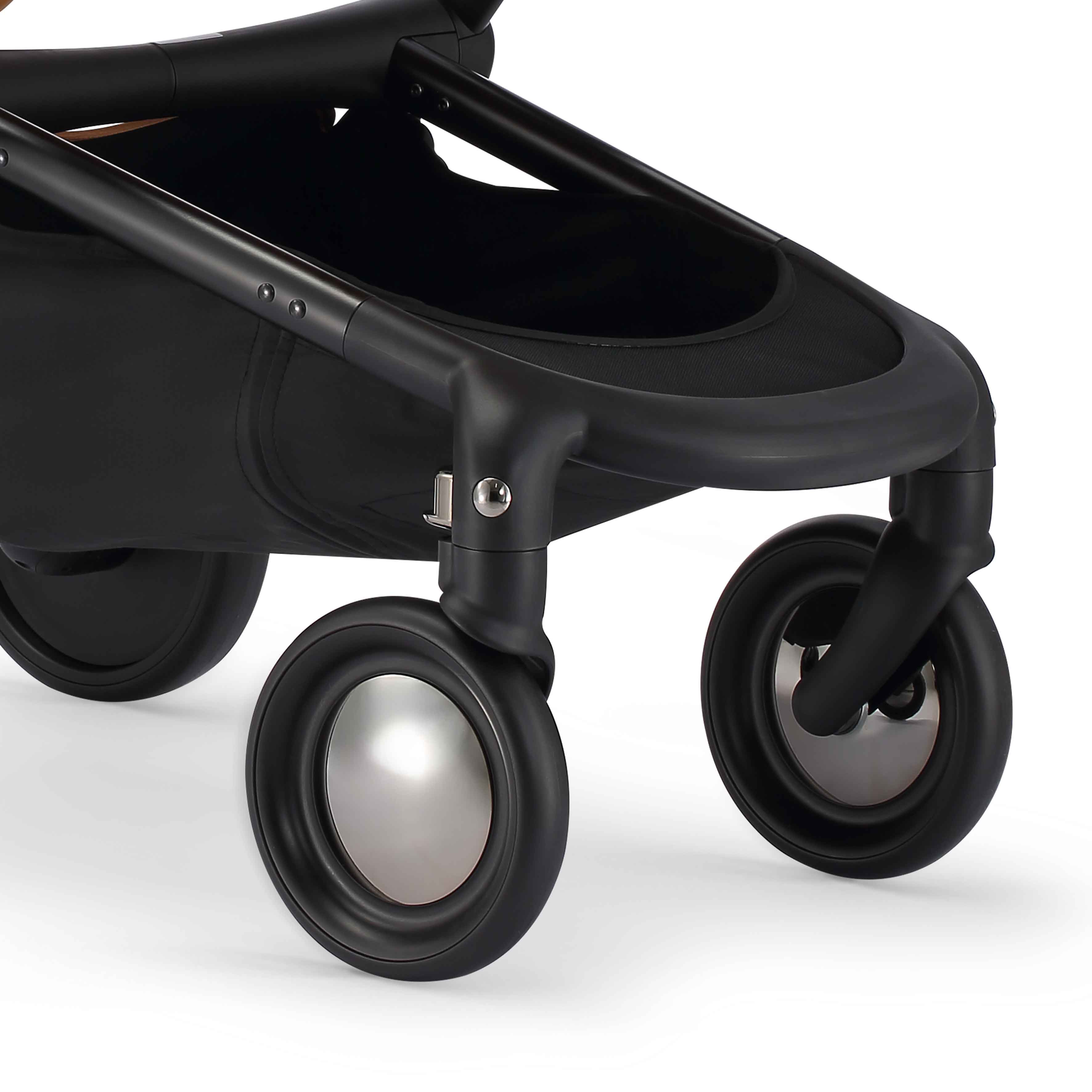 close up of the front wheels with reflective hubcaps on mima creo stroller 