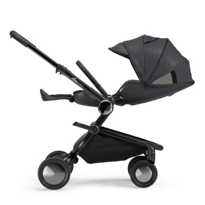 side view of parent facing fully reclined mima creo compact stroller in black 