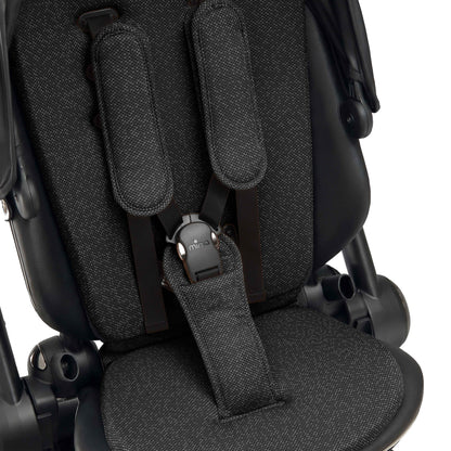 interior view of the seat pad and safety harness on mima creo in black 