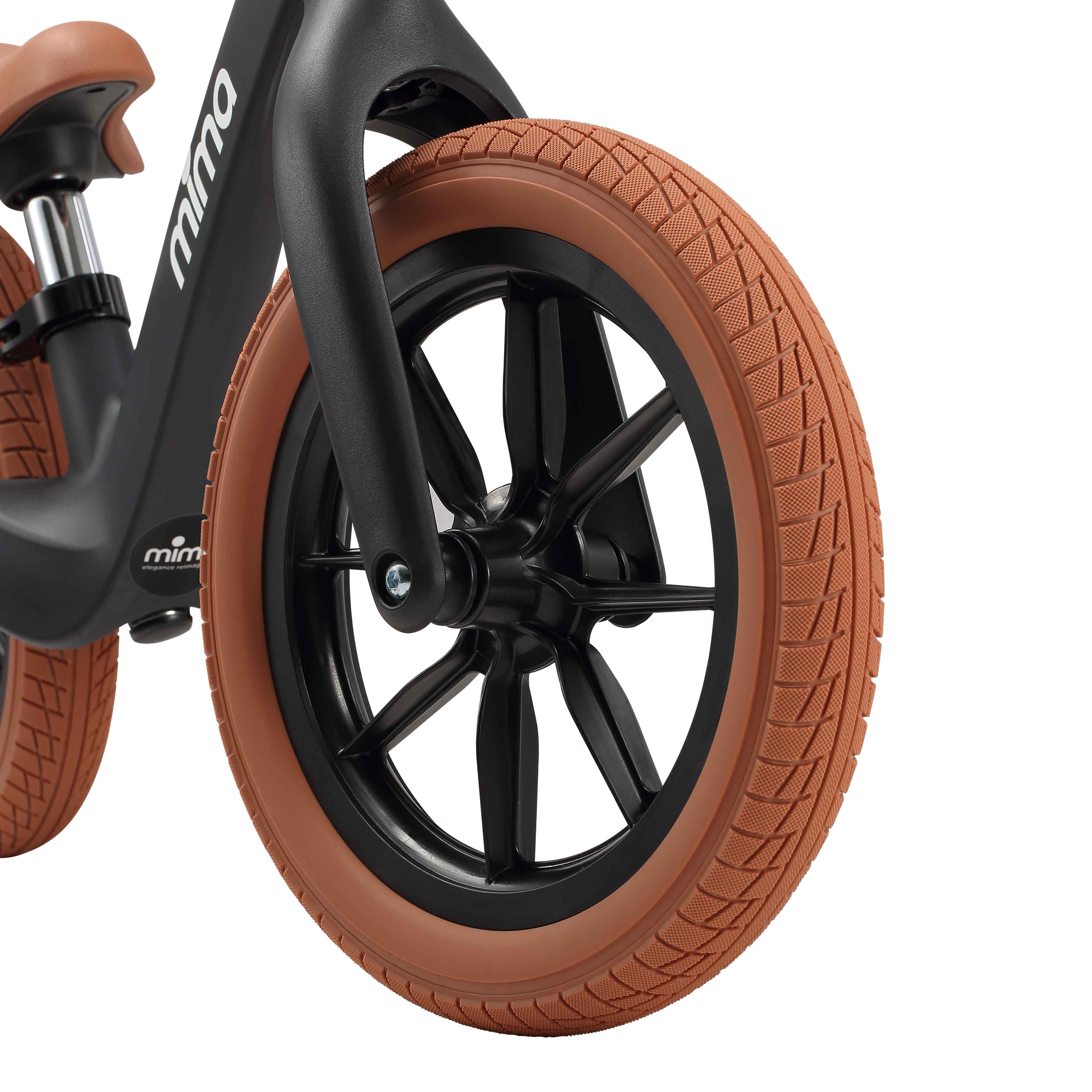 close up of the front wheel on mima zoom lite balance bike in black 