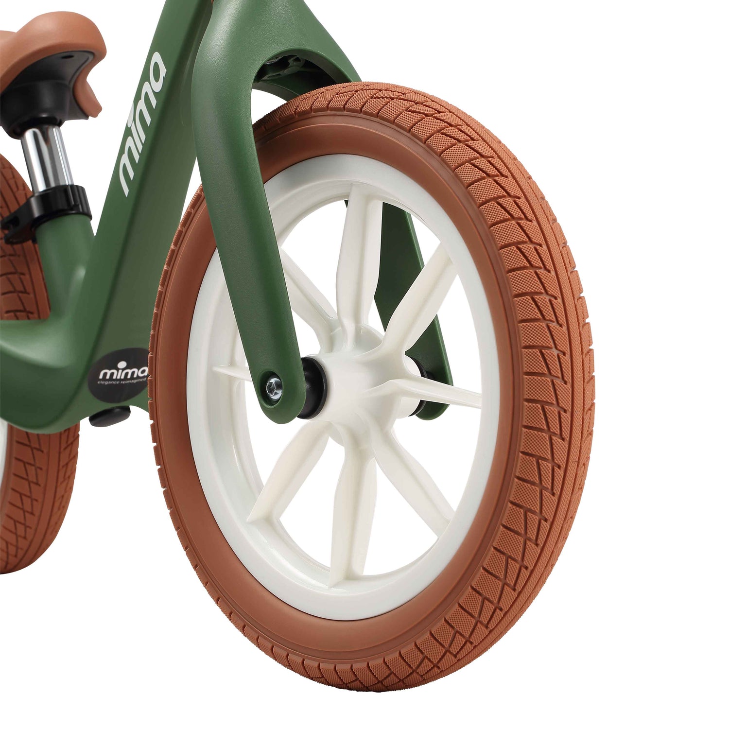 close up of the front wheel on mima zoom lite balance bike in green 