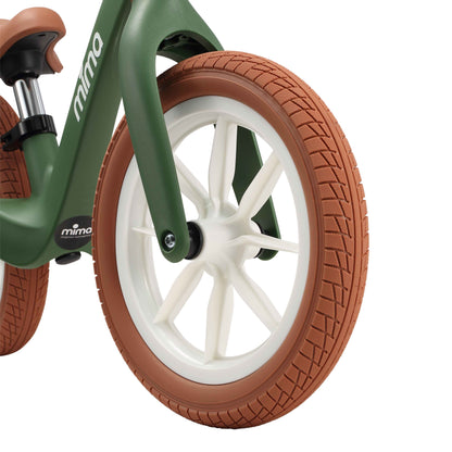 close up of the front wheel on mima zoom lite balance bike in green 