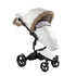 How to keep baby warm in stroller Xari winter outfit white Snow White Mima Xari stroller with winter outfit, left front view, includes wind protector, footmuff and hand muff